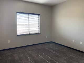 master bedroom with a window and shades open