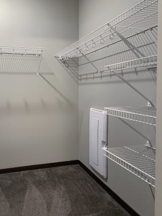 Walk-in closet with shelving and rods of the master bedroom in the Grand Canyon floorplan
