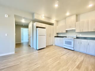 3 bed 2 bath kitchen with stove, range hood, and refrigerator