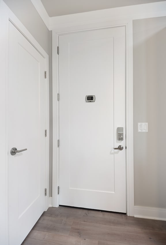 a white door with a sensor on the side of it