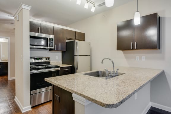 Kitchen With Granite Countertops, Espresso Cabinetry &amp; Stainless Steel Appliances