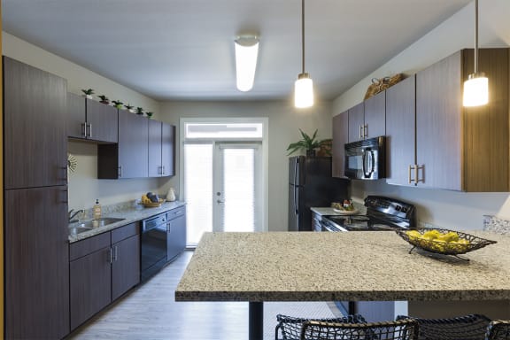Ascent 430 apartments kitchen with a granite countertop peninsula