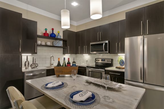 the aster apartments kitchen equipped with whirlpool stainless steel appliances