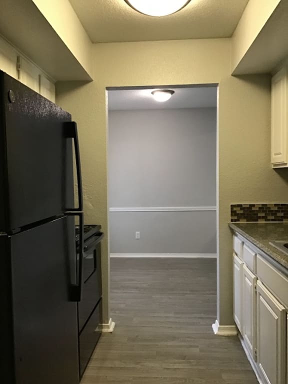 a kitchen with a refrigerator freezer and a sink