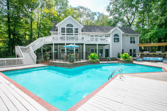 Sparkling swimming pool with sundeck and view of the clubhouse at Summerchase at Riverchase apartments for rent in Hoover, AL