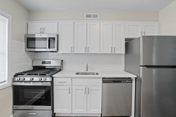 Luxury 2 Bedroom Apartment Kitchen with white cabinets and stainless steal appliances