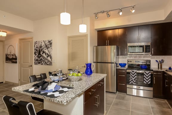 Kitchen Island with Pendant Lighting &amp; USB Outlets at Azura Luxury Apartments in Kendall, FL