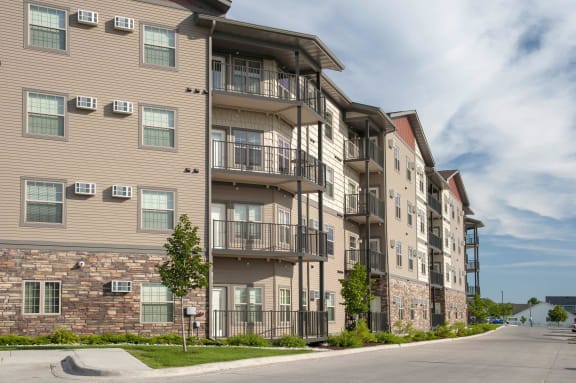 Exterior of Cardinal Point Apartments showcasing balconies and patios in select units.