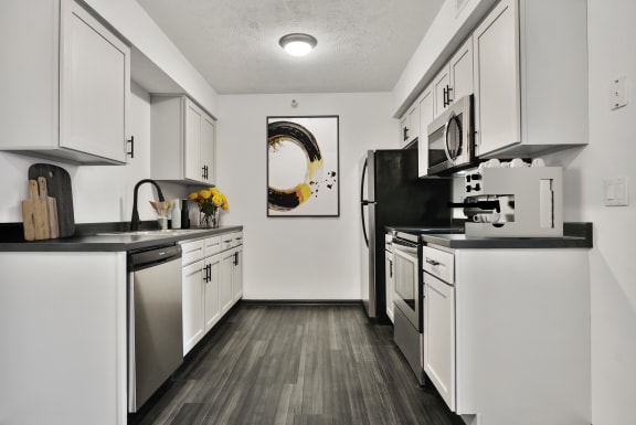 Spacious kitchen with white cabinetry, plenty of storage, and stainless steel appliances.