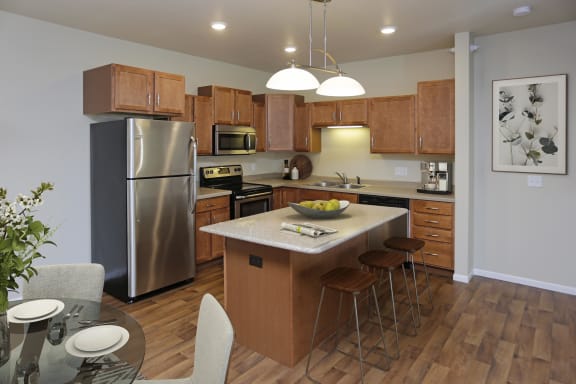 Spacious and bright kitchen with stainless steel appliances and a large kitchen island.