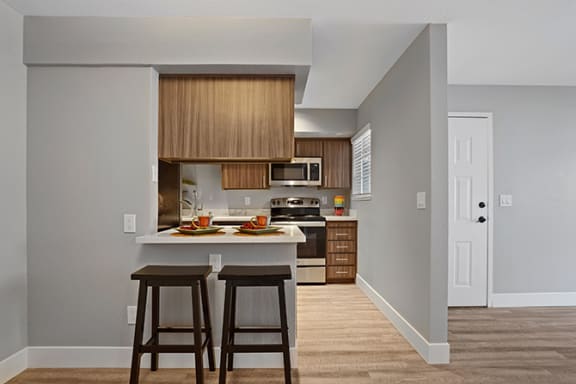 Fitted Kitchen With Island Dining at Clayton Creek Apartments, California