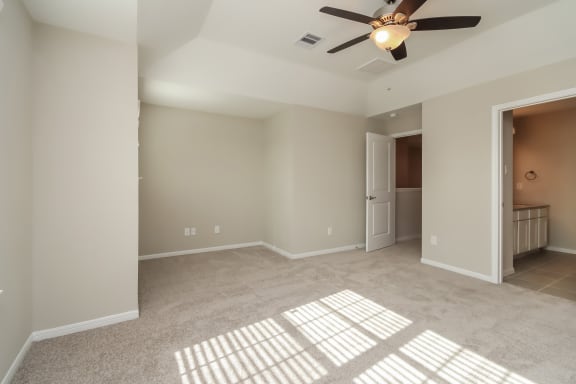 Spacious bedroom with ceiling fan at Pradera Oaks in Rosharon, TX