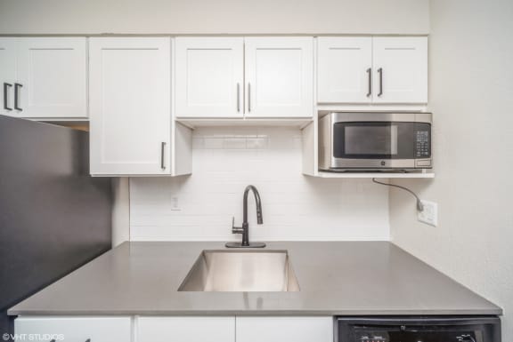Bright white cabinets and a built-in microwave