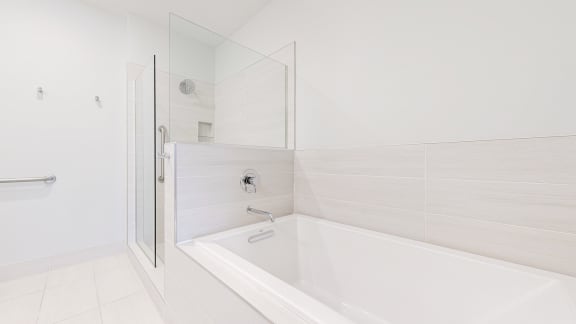 a bathroom with a bathtub and shower