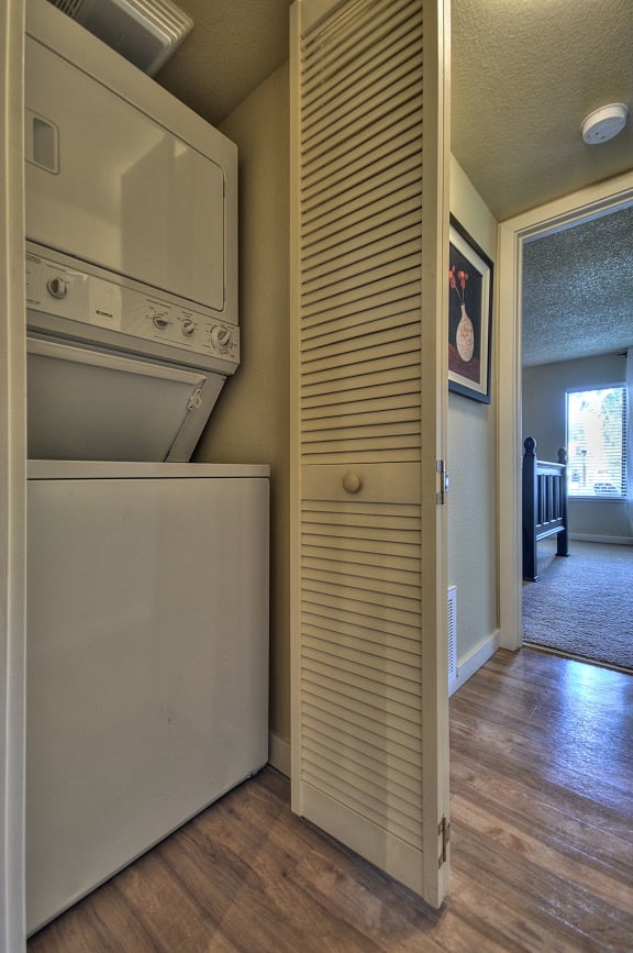 Stackable washer and dryer located inside the apartment home.