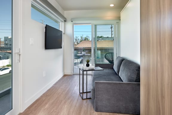 mysuite-at-cara-west-la-furnished-apartments-interior-living-room-couch-balcony-los-angeles-co-living