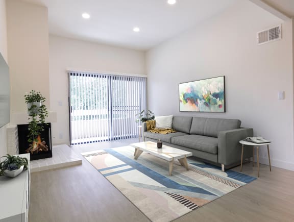 a living room with a couch coffee table and fireplace