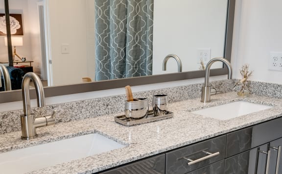 Stunning large bathroom with double sinks in new apartments  at Link Apartments&#xAE; Montford, North Carolina