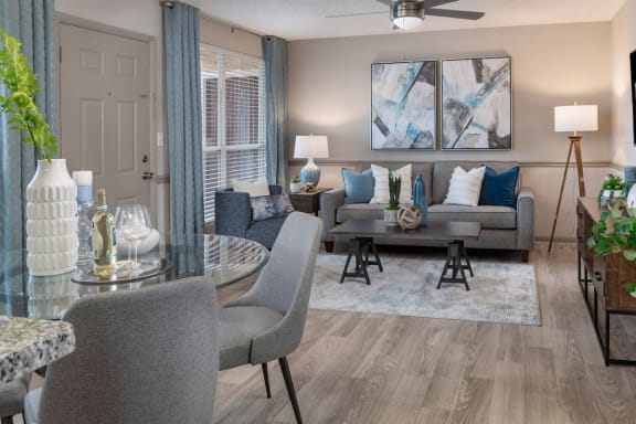 living room with hardwood-style flooring, model furniture, and modern ceiling fan at Preserve at Cedar River Apartments, Florida, 32210