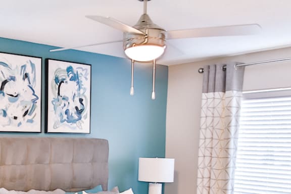 modern ceiling fan in bedroom with accent wall at Berry Falls Apartments, Vestavia Hills, 35216