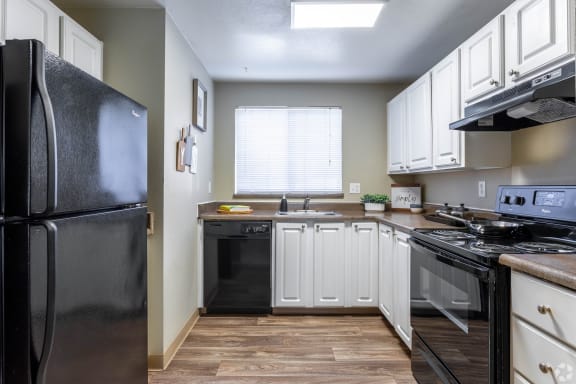 Kitchen with Stainless Steel Appliances and Refrigerator at Copper Ridge Apartments, Washington, 98055