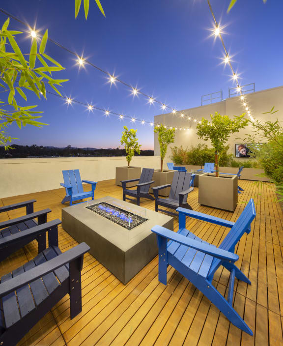 Firepits and Adirondack chairs under the dusk sky Luxury Amenities The Q Topanga