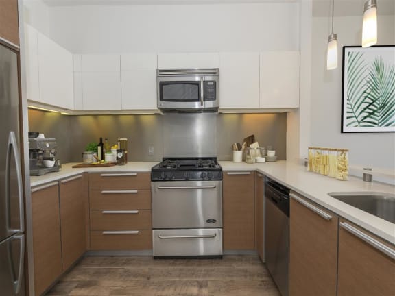 Apartments in Daly City CA - Spacious Kitchen Featuring Convenient Stainless Steel Amenities Such as Fridge, Stove, Microwave, and Dishwasher