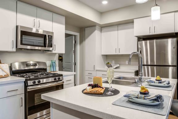 Apartments for Rent in Sparks, NV - Lyfe at the Marina Kitchen with Stainless Steel Appliances, Modern White Wood Cabinets, and Stylish Decor