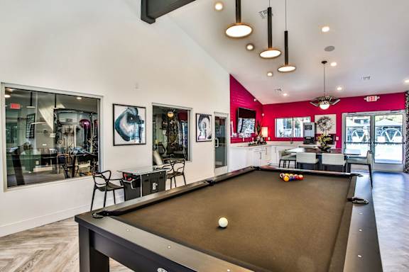 Pool table with the kitchen area in the background.