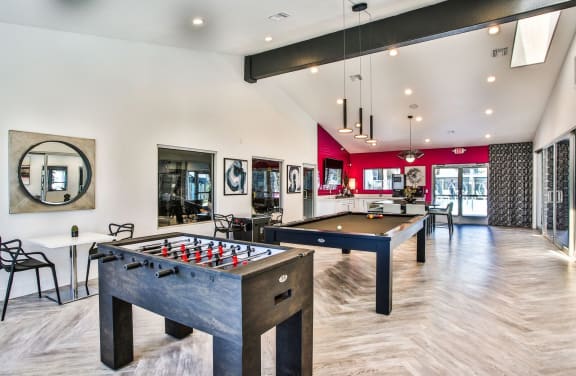 Club house with foosball and pool table.