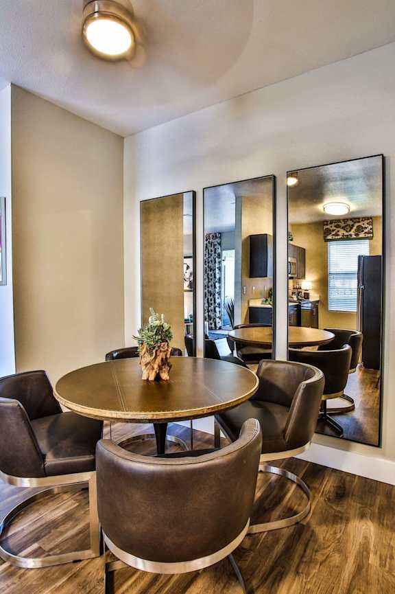 Dining area with round table and four chairs.
