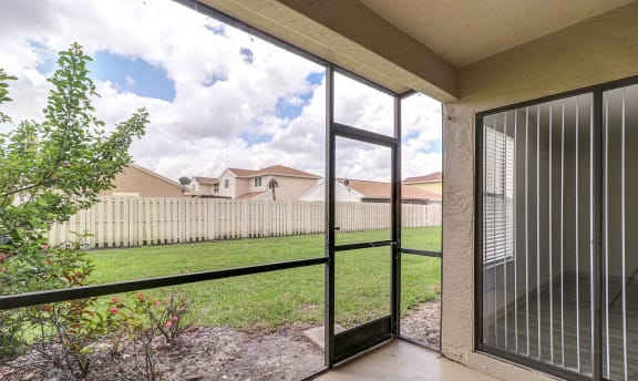 Screened In Patio with Lawn Views at Water&#x27;s Edge Apartments, Sunrise, FL