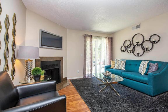 Television And Fireplace In Living Room at Woodland Hills Apartments, Colorado Springs, CO