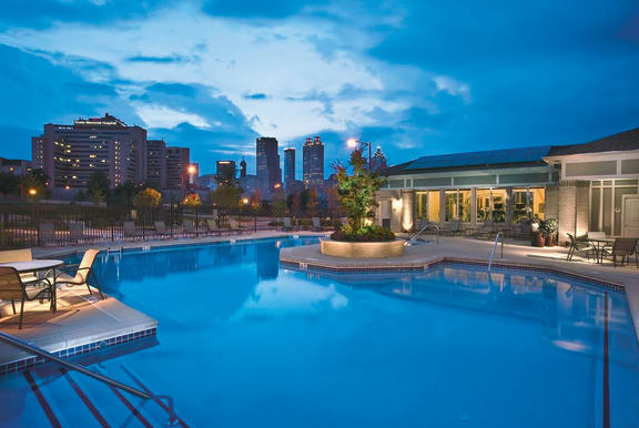 Nighttime view of Community Pool Nighttime view of community pool with Atlanta skyline in background at Ashley at Auburn Pointe in Atlanta, GA