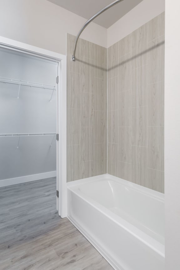 a large white bathtub in a bathroom in a 555 waverly unit