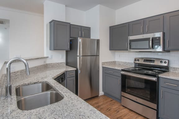 Stainless Steel Sink With Faucet In Kitchen at The Jax Apartments, San Antonio, 78230