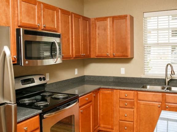 Maple cabinets and stainless steel appliances in kitchen at Fenwyck Manor Apartments, Chesapeake, VA, 23320