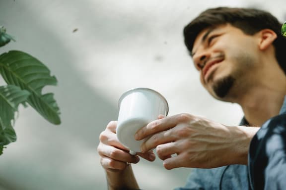 Resident Enjoying Coffee at River Pointe Apartments