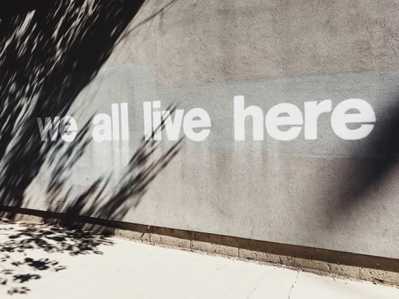 We All Live Here Message on the Wall at The District at Forestville