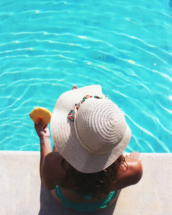 Resident Sitting By the Pool at The District at Forestville
