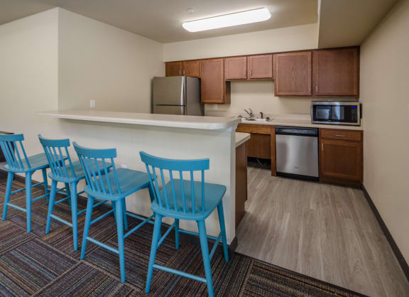 blue chairs at counter in kitchen