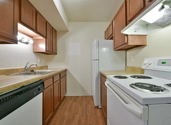 White kitchen appliances at Perry Place Apartments in Grand Blanc, MI