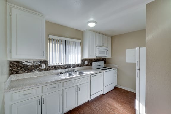 Kitchen With White Cabinetry And Appliances at Highlander Park Apts, Riverside, CA, 92507