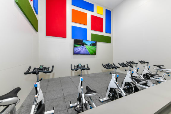 Health and Fitness Club including Spin Studio with Flat Screen TVs and more at Pointe Royal Townhome Apartments, Overland Park, KS 66213