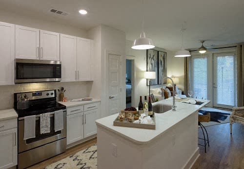 Open-Concept Kitchens with Quartz Countertops and Classic Shaker Cabinets at Echo at North Pointe Center Apartment Homes, Alpharetta, GA 30009
