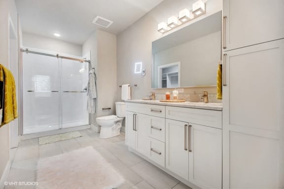Double vanity, 19 inch television in the mirror, heated floors, and LED makeup mirror