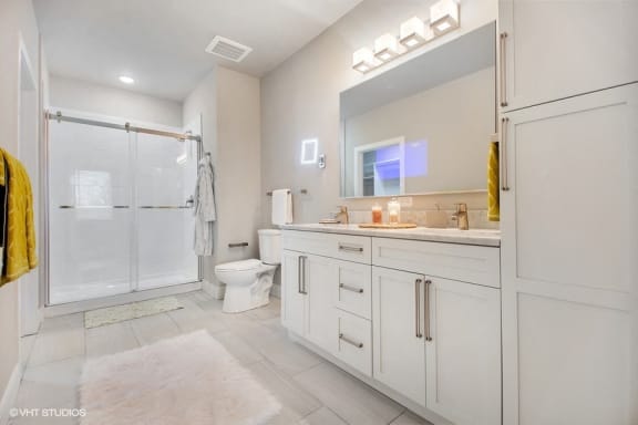 Double vanity, 19 inch television in the mirror, heated floors, and LED makeup mirror