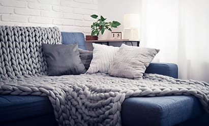 Blanket and pillows on couch