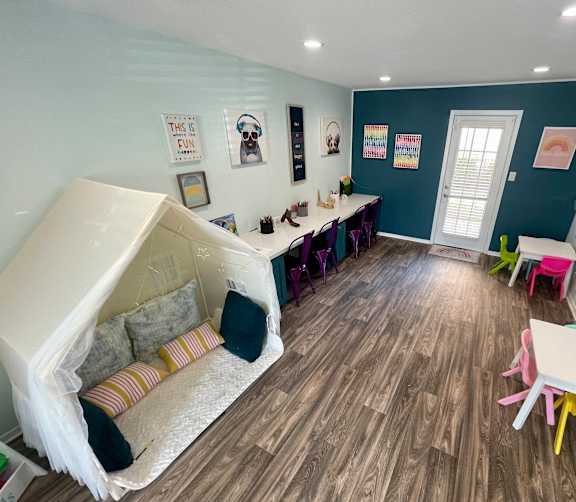 a room with a slide and a table and chairs  at The Alara, Houston, TX