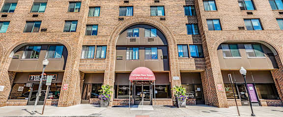 A tall building with a red awning in front.
